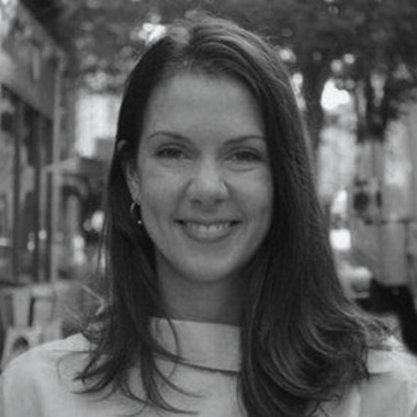 a black and white photo of a woman smiling