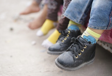 Children feet barefoot and with shoes