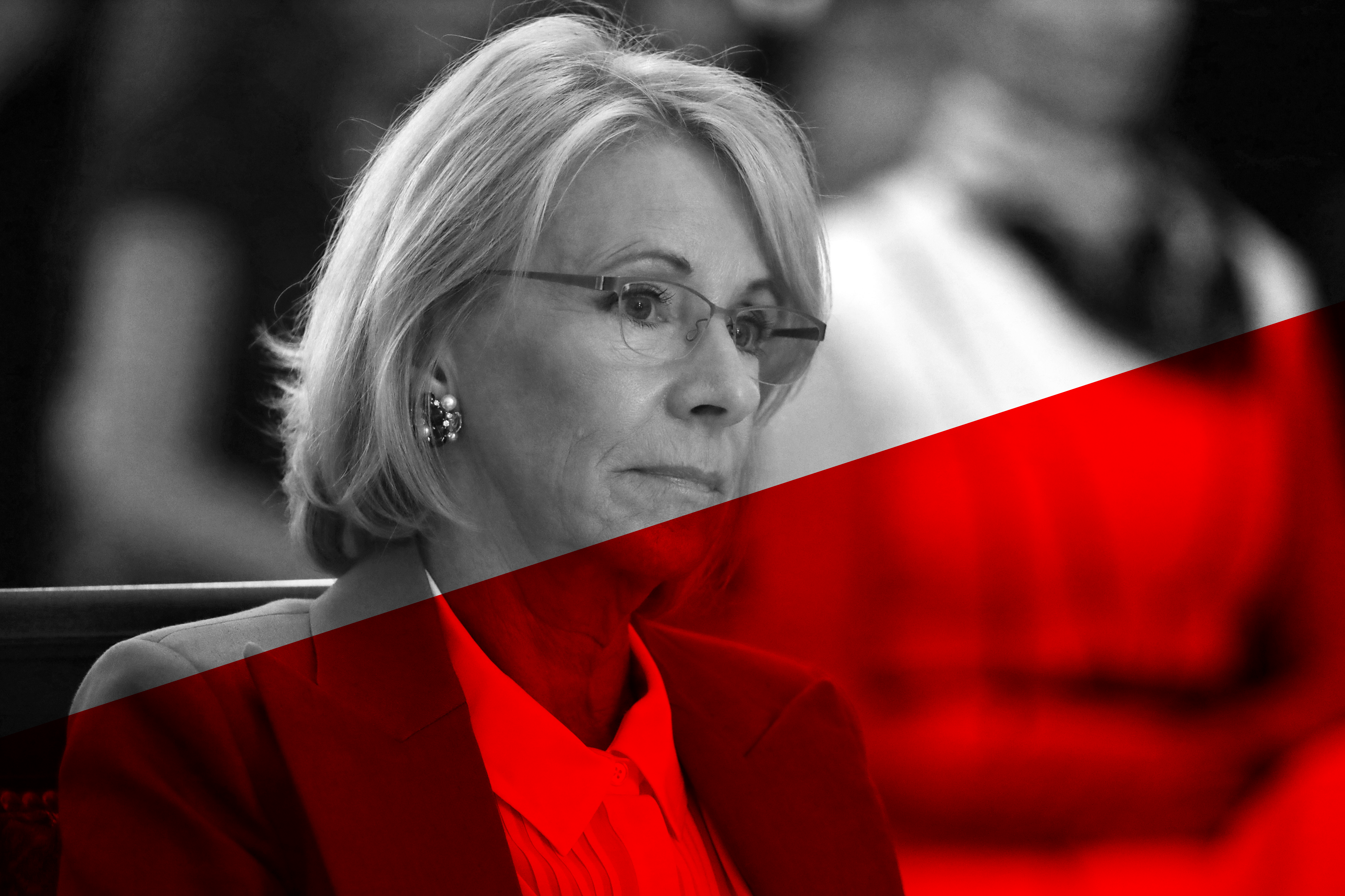 a woman wearing glasses and a red jacket