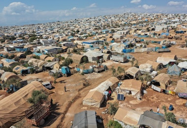 ATMEH, SYRIA - SEPTEMBER 17: A general view of the village of Atmeh which hosts nearly 1 million displaced Syrians near the Syrian-Turkish border in Idlib Province September 17, 2019 in Atmeh, Syria. Turkey’s president, Recep Tayyip Erdogan, is pushing for the creation of an expanded “safe zone” in northern Syria where his government hopes to resettle up to three million Syrian refugees. The United States and Turkey recently started joint patrols of a small buffer zone along the border, but it’s a far cry from the 20-by-300 mile strip proposed by Mr. Erdogan, and no other power involved in the war as agreed to the idea. Turkey has warned that, if it doesn’t receive more international support for the safe zone, it might relax its migration controls and reopen the route for refugees to enter Europe. More than 3.6 million Syrian refugees have settled in Turkey after fleeing the civil war that began in 2011. (Photo by Burak Kara/Getty Images)