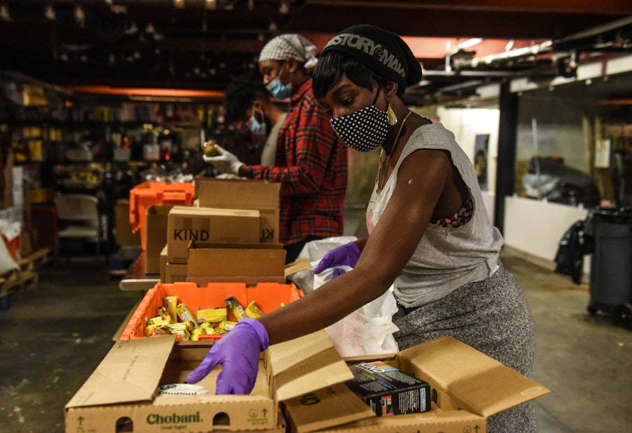 NEW YORK, NY - MAY 20 :  Employees work to create to- go donation meals for a company called Collective Fare on May 20, 2020 in the Brownsville neighborhood in the Brooklyn borough in New York City. Collective Fare works with World Central Kitchen to get raw ingredients that they cook into gourmet meals. New York City is currently in its ninth week of lockdown with non-essential businesses still closed. (Photo by Stephanie Keith/Getty Images)