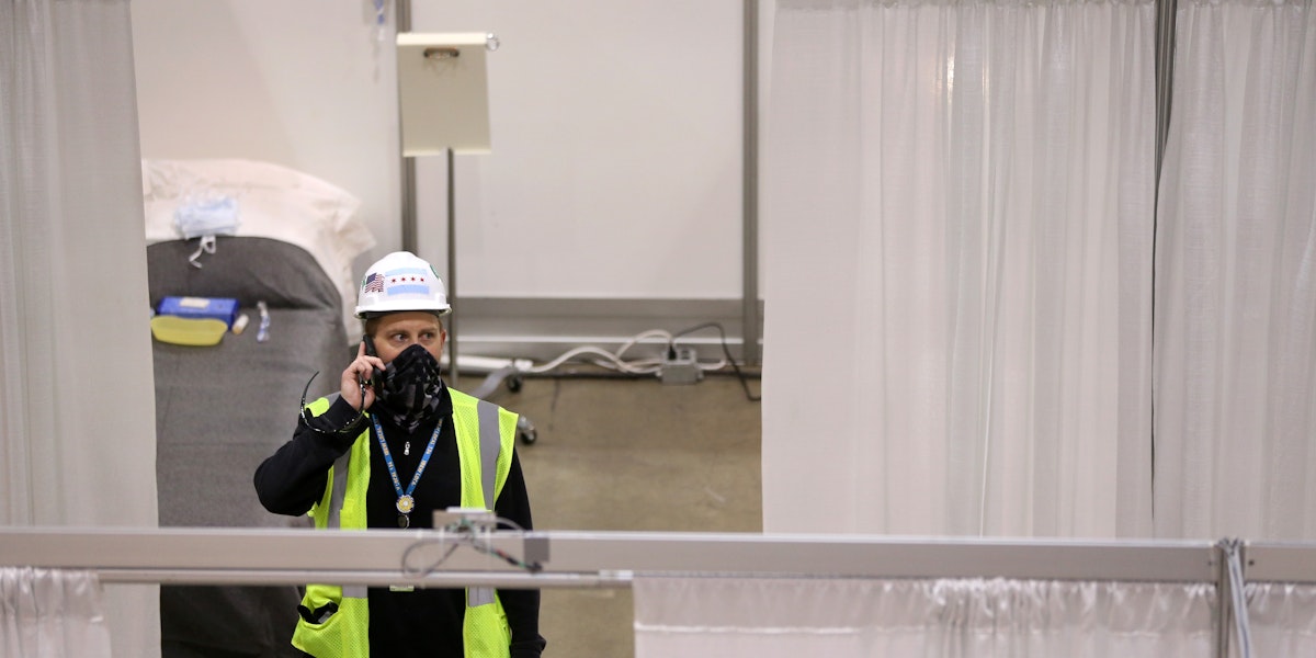 CHICAGO, IL - APRIL 3:  Construction workers put the finishing touches on Hall C Unit 1 of the COVID-19 alternate site at McCormick Place on Friday, April 3, 2020 in Chicago, Illinois. Gov. Pritzker And Mayor Lightfoot toured what will be a 3,000-bed medical facility to treat less seriously-ill COVID-19 patients built in a collaborative effort involving the Illinois National Guard, U.S. Army Corps of Engineers and trade unions.   (Photo by Chris Sweda-Pool via Getty Images)