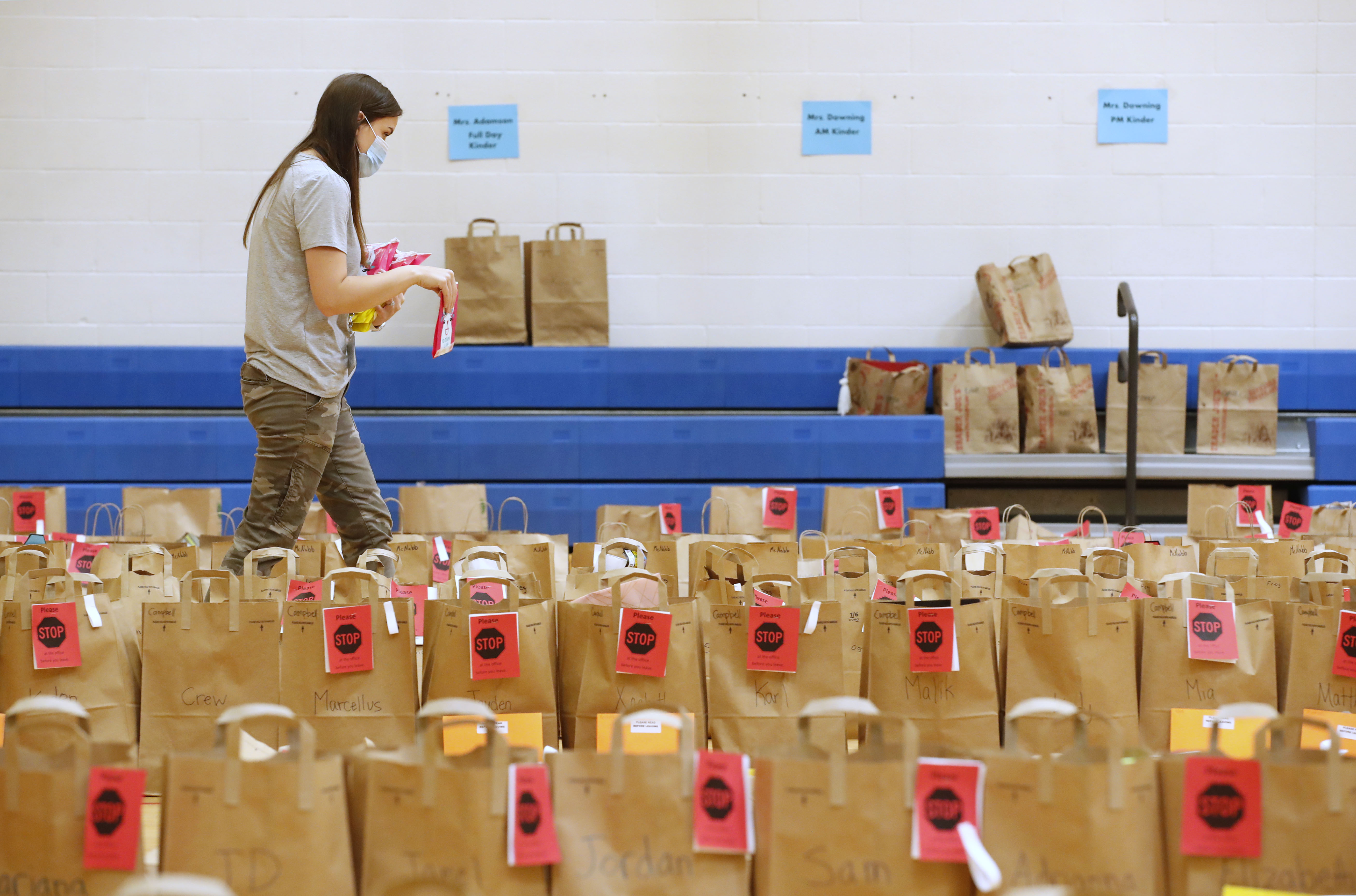 PROVO, UT - MAY 18:  A teacher puts final items into paper bags with the personal belongings of students at Freedom Preparatory Academy waiting for parents to come and pick them up on May 18, 2020 in Provo, Utah. Freedom Academy an elementary school was closed on March 16, 2020 along with all other school in Utah due to the order of the Utah Governor due to the COVID-19 pandemic. (Photo by George Frey/Getty Images)