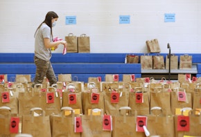 PROVO, UT - MAY 18:  A teacher puts final items into paper bags with the personal belongings of students at Freedom Preparatory Academy waiting for parents to come and pick them up on May 18, 2020 in Provo, Utah. Freedom Academy an elementary school was closed on March 16, 2020 along with all other school in Utah due to the order of the Utah Governor due to the COVID-19 pandemic. (Photo by George Frey/Getty Images)