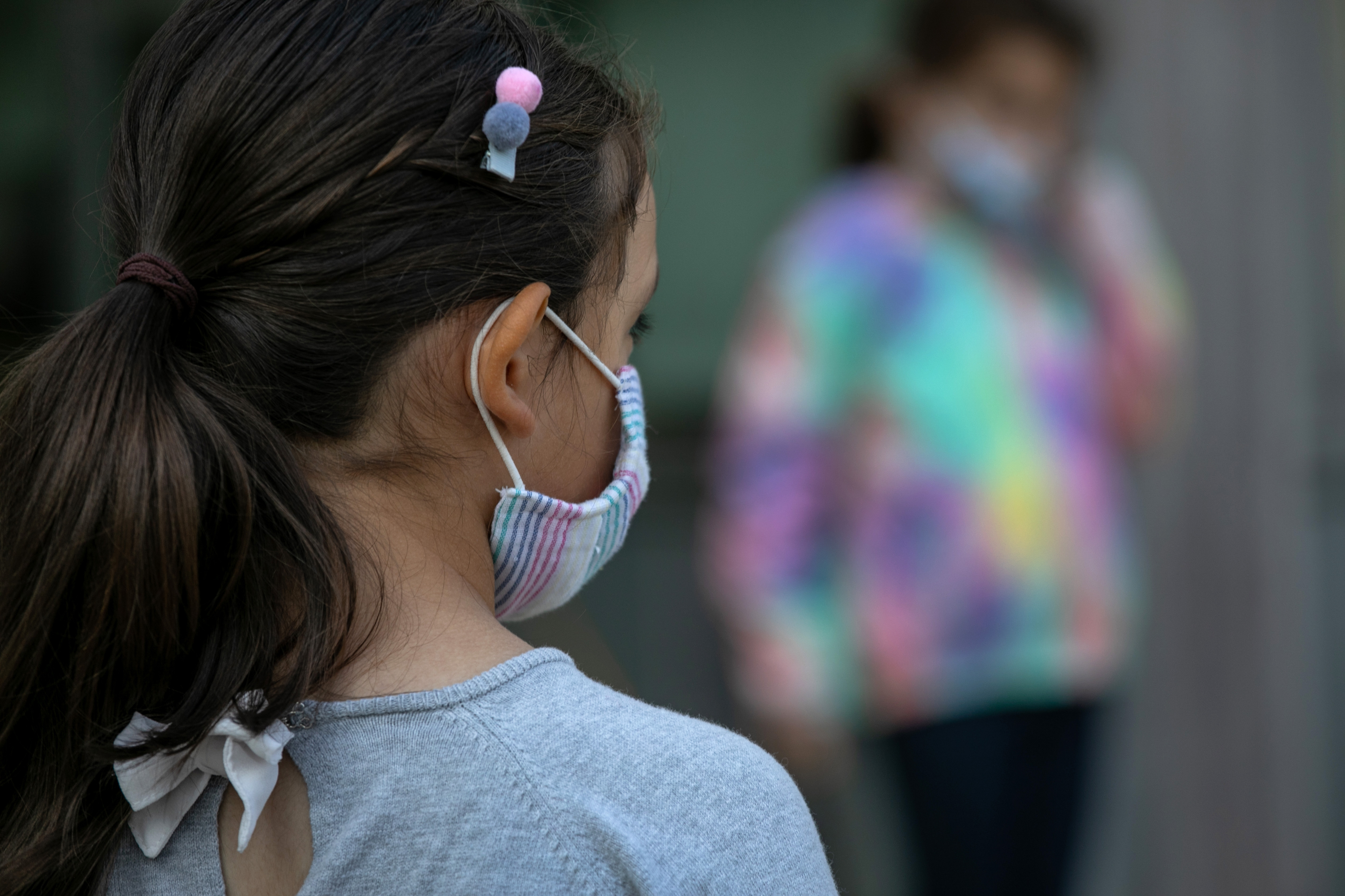 STAMFORD, CONNECTICUT - SEPTEMBER 23: Masked school children wait to have their portraits taken during picture day at Rogers International School on September 23, 2020 in Stamford, Connecticut. Students lined up outside while socially distanced due to COVID-19 precautions to be individually photographed. Most students at Stamford Public Schools are taking part in a hybrid education model, attending in-school classes every other day and distance learning the rest. (Photo by John Moore/Getty Images)