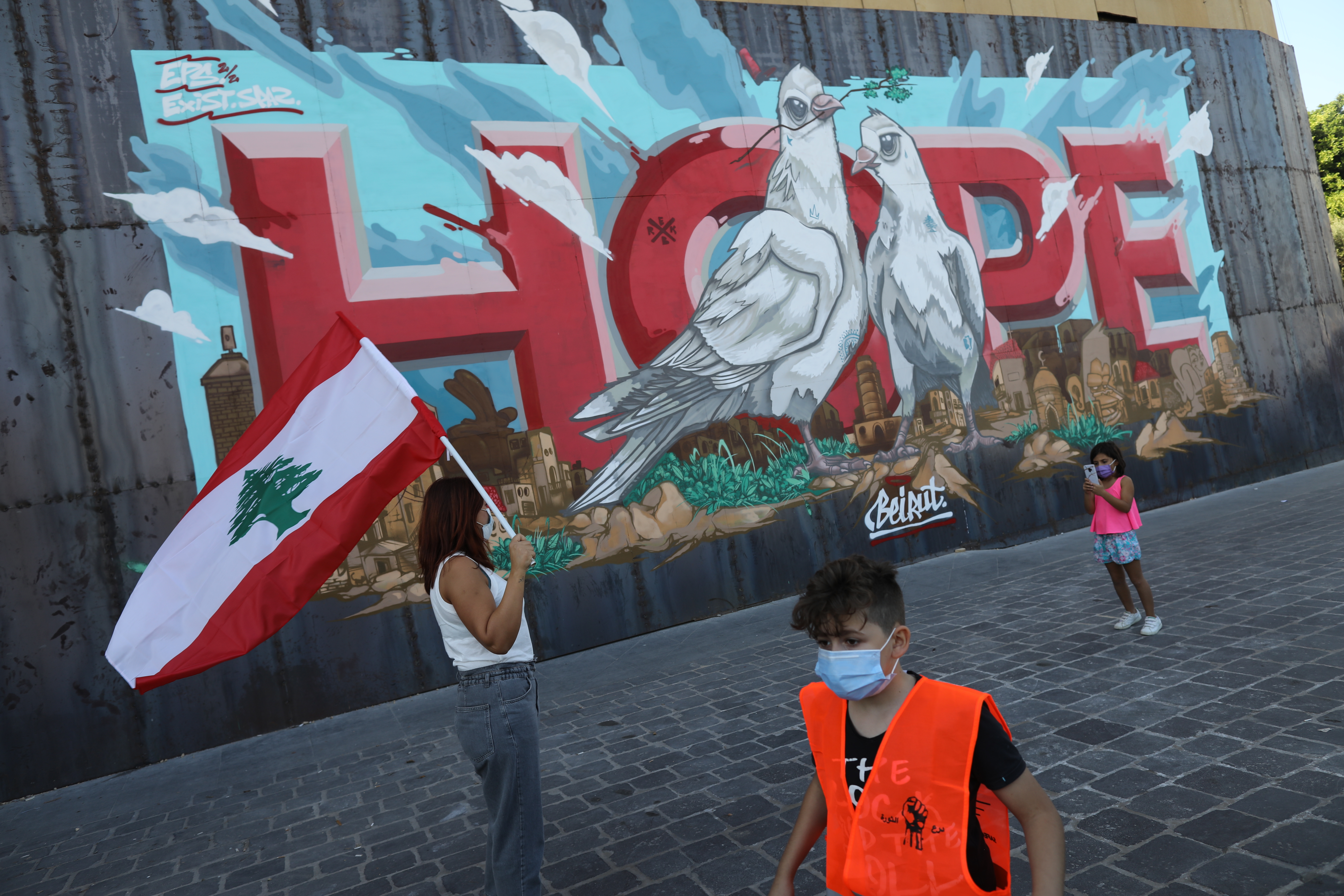 BEIRUT, LEBANON - OCTOBER 17: People walk past a 
