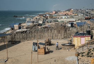 GAZA CITY, GAZA - AUGUST 30: A man leaves after closing his cafe on the corniche of the Gaza Strip, due to the coronavirus lockdown on August 30, 2020 in Gaza City, Gaza. Fears are growing that the already crippled health care system will not be able to cope, as coronavirus cases continue to rise throughout the Gaza strip. In the past weeks Israel has responded to incendiary balloons launched from Gaza, with airstrikes and further blockade restrictions adding to the pressure on residents already struggling with just four hours of electricity a day. In the past week, the Ministry of Health and Security Services in the Gaza Strip have issued strict lockdown and movement restrictions, to try to contain the rising infections. On August 31, Hamas agreed to temporarily end hostilities with Israel in exchange for a cash infusion from Qatar and an agreement with Israel to once again allow fuel to Gaza’s power station in a bid to calm the ongoing situation and deal with the latest coronavirus outbreak. Since March, there have reportedly been over 500 coronavirus cases with 5 confirmed deaths in the Gaza strip. (Photo by Fatima Shbair/Getty Images)