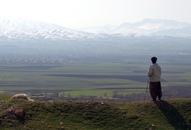 HALABJA, IRAQ - FEBRUARY 24:  A shepherd stands looking out towards the mountains where a mass grave site of most of the victims of the March 16, 1988 chemical attacks on Halabja are buried February 24, 2004 in Halabja, Iraq. In Halabja, approximately 5,000 innocent civilians, mostly women and children (75 percent), immediately perished due to chemical attacks committed allegedly by the Iraqi regime. The chemical attacks were said to have involved mustard gas, nerve agents and possibly cyanide. The attack on Halabja took place amidst the infamous al-Anfal campaign, in which former Iraqi Dictator Saddam Hussein is alleged to have brutally repressed yet another of the Kurdish revolts during the Iran-Iraq war at the time.  (Photo by Marco Di Lauro/Getty Images)