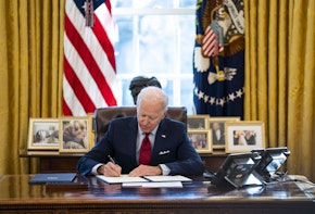 WASHINGTON, DC - JANUARY 28: U.S. President Joe Biden signs executive actions in the Oval Office of the White House on January 28, 2021 in Washington, DC. President Biden signed a series of executive actions Thursday afternoon aimed at expanding access to health care, including re-opening enrollment for health care offered through the federal marketplace created under the Affordable Care Act. (Photo by Doug Mills-Pool/Getty Images)