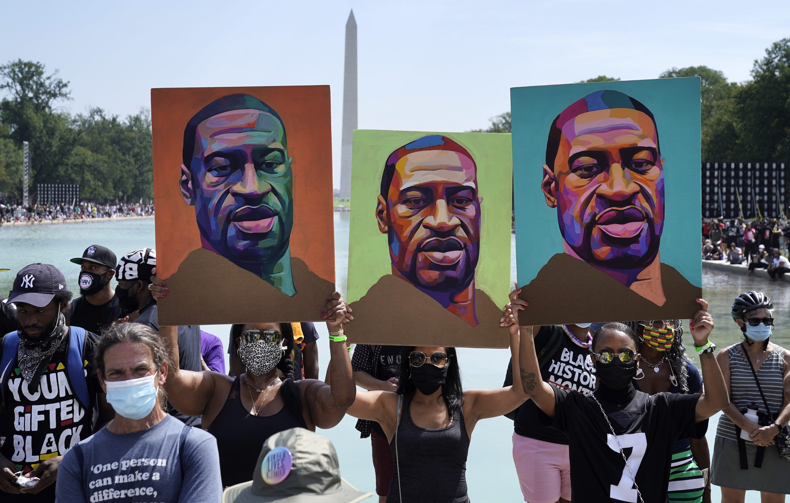WASHINGTON, DC - AUGUST 28: Attendees hold images of George Floyd as they participate in the March on Washington at the Lincoln Memorial August 28, 2020 in Washington, DC. Today marks the 57th anniversary of Rev. Martin Luther King Jr.'s 