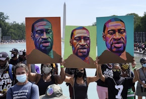 WASHINGTON, DC - AUGUST 28: Attendees hold images of George Floyd as they participate in the March on Washington at the Lincoln Memorial August 28, 2020 in Washington, DC. Today marks the 57th anniversary of Rev. Martin Luther King Jr.'s 