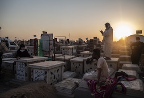 NAJAF, IRAQ - AUGUST 30: Relatives bury a family member who died from coronavirus at the Wadi Al-salam cemetery on August 30, 2020 in Najaf, Iraq. On September 4, Iraq recorded 5,036 coronavirus cases, its biggest daily increase since the start of the outbreak. The surge has prompted warnings from Iraq's health minister and WHO that the country could be on the verge of a health crisis as pressure mounts on the already strained healthcare system. Since the first case was recorded in February, Iraq has recorded 252,075 total cases and 7,359 deaths. (Photo by Hawre Khalid/Getty Images)