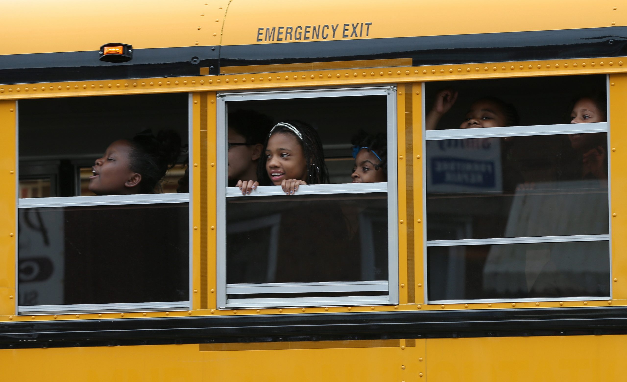 BALTIMORE, MD - MAY 01:  Children riding home from school on a school bus watch as Baltimore residents celebrate at the corner of West North Avenue and Pennsylvania Avenue after Baltimore authorities released a report on the death of Freddie Gray  on May 1, 2015 in Baltimore, Maryland. Marilyn Mosby, Baltimore City State's Attorney, ruled the death of Freddie Gray a homicide and that criminal charges will be filed. Gray, 25, was arrested for possessing a switch blade knife on April 12 outside the Gilmor Houses housing project on Baltimore's west side. According to his attorney, Gray died a week later in the hospital from a severe spinal cord injury he received while in police custody.  (Photo by Win McNamee/Getty Images)