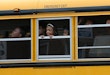 BALTIMORE, MD - MAY 01: Children riding home from school on a school bus watch as Baltimore residents celebrate at the corner of West North Avenue and Pennsylvania Avenue after Baltimore authorities released a report on the death of Freddie Gray on May 1, 2015 in Baltimore, Maryland. Marilyn Mosby, Baltimore City State's Attorney, ruled the death of Freddie Gray a homicide and that criminal charges will be filed. Gray, 25, was arrested for possessing a switch blade knife on April 12 outside the Gilmor Houses housing project on Baltimore's west side. According to his attorney, Gray died a week later in the hospital from a severe spinal cord injury he received while in police custody. (Photo by Win McNamee/Getty Images)