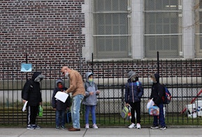 NEW YORK, NEW YORK - DECEMBER 07: Children returning to school line up before entering P.S. 179 Kensington on December 07, 2020 in New York City. The New York City public school system opened for in-person learning 10 days after being shut down by Mayor Bill De Blasio due to a rising number of coronavirus (COVID-19) positive cases in the city. (Photo by Michael M. Santiago/Getty Images)