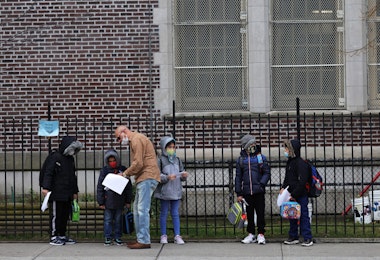 NEW YORK, NEW YORK - DECEMBER 07: Children returning to school line up before entering P.S. 179 Kensington on December 07, 2020 in New York City. The New York City public school system opened for in-person learning 10 days after being shut down by Mayor Bill De Blasio due to a rising number of coronavirus (COVID-19) positive cases in the city. (Photo by Michael M. Santiago/Getty Images)
