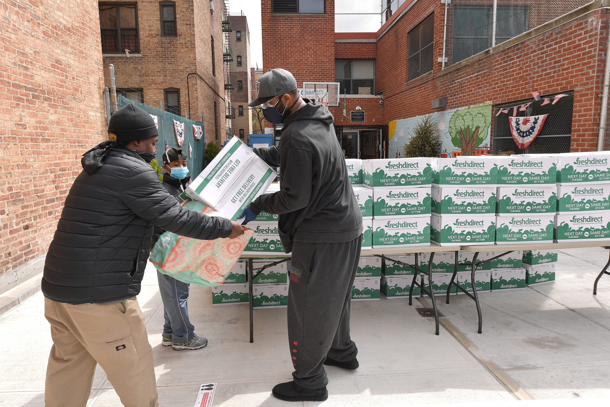 NEW YORK, NEW YORK - APRIL 08: Former professional baseball player CC Sabathia (R) distributes pantry boxes to Boys And Girls Club families at the Belmont Community Day Care Center on April 08, 2020 in The Bronx Borough of New York City. (Photo by Michael Loccisano/Getty Images)