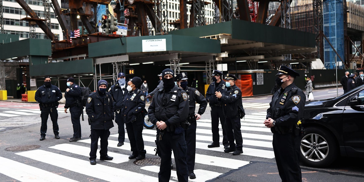 NEW YORK, NEW YORK - APRIL 02: NYPD officers stand watch after a person fell while climbing the side of a Chase Bank location as demonstrators gather in Midtown Manhattan on April 02, 2021 in New York City. Members of the Extinction Rebellion NYC and various organizations held a rally and a march in solidarity with the #StopTheMoneyPipeline coalition, urging President Joe Biden to stop the construction of the Line 3 pipeline in Minnesota. (Photo by Michael M. Santiago/Getty Images)