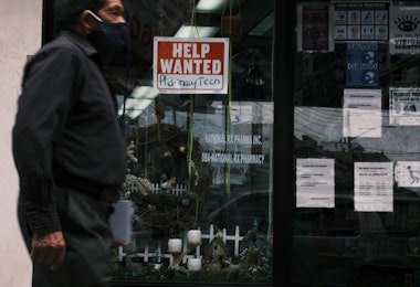 NEW YORK, NEW YORK - JUNE 04: People walk by a Help Wanted sign in the Queens borough of New York City on June 04, 2021 in New York City. The U.S. economy added 559,000 jobs in May, bringing the unemployment rate down to 5.8 percent from 6.1 percent. Despite the positive economic news, millions of Americans are still looking for work or are in need of financial, food, and housing assistance. (Photo by Spencer Platt/Getty Images)