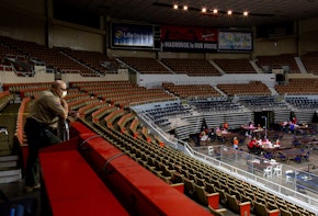 PHOENIX, AZ - MAY 01: An Arizona Rangers watches as contractors working for Cyber Ninjas, who was hired by the Arizona State Senate, examine and recount ballots from the 2020 general election at Veterans Memorial Coliseum on May 1, 2021 in Phoenix, Arizona. The Maricopa County ballot recount comes after two election audits found no evidence of widespread fraud.  (Photo by Courtney Pedroza/Getty Images)