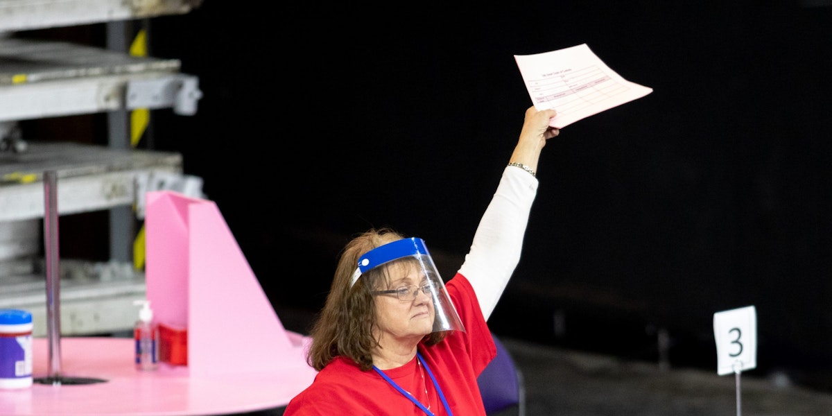 PHOENIX, AZ - MAY 01: A contractor working for Cyber Ninjas, who was hired by the Arizona State Senate, works to recount ballots from the 2020 general election at Veterans Memorial Coliseum on May 1, 2021 in Phoenix, Arizona. The Maricopa County ballot recount comes after two election audits found no evidence of widespread fraud in Arizona.  (Photo by Courtney Pedroza/Getty Images)