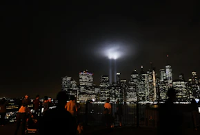 NEW YORK, NY - SEPTEMBER 11: The 'Tribute in Light' memorial lights up lower Manhattan near One World Trade Center on September 11, 2018 in New York City. The tribute at the site of the World Trade Center towers has been an annual event in New York since March 11, 2002.Throughout the country services are being held to remember the 2,977 people who were killed in New York, the Pentagon and rural Pennsylvania in the terrorist attacks on September 11, 2001. (Photo by Spencer Platt/Getty Images)