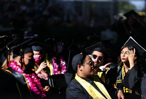LOS ANGELES, CALIFORNIA - JULY 27: Cal State Los Angeles graduates sit at their commencement ceremony which was held outdoors beneath a tent on campus on July 27, 2021 in Los Angeles, California. Commencement ceremonies for graduates from the classes of 2021 and 2020 are being held outdoors over seven days following delays due to the COVID-19 pandemic. (Photo by Mario Tama/Getty Images)