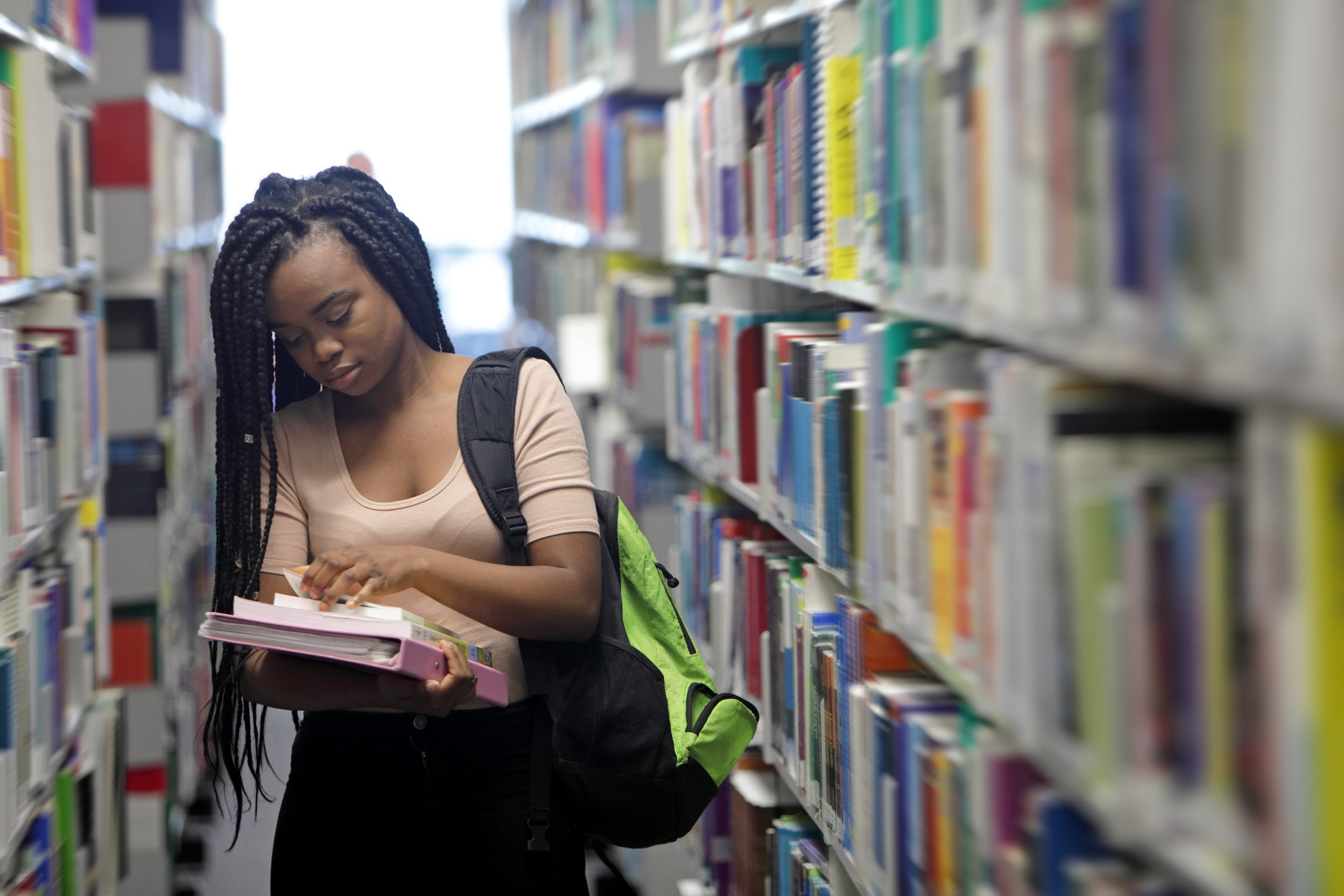 lady holding books in a library