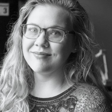 a black and white photo of a woman wearing glasses