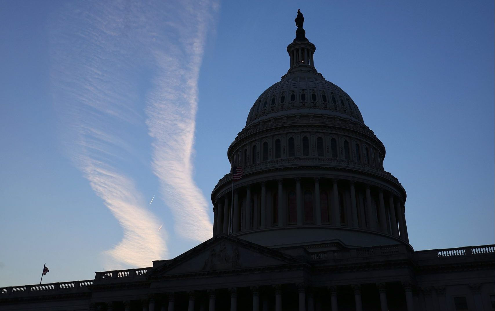WASHINGTON, DC - NOVEMBER 18: The sun sets behind the U.S. Capitol on November 18, 2021 in Washington, DC. Following the final Congressional Budget Office cost estimate, House Democrats are hoping to vote on President Joe Biden's $1.75 trillion social benefits and climate legislation Thursday.  (Photo by Chip Somodevilla/Getty Images)