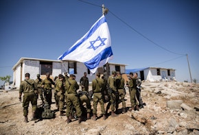 WEST BANK - JULY 02: Members of the Israeli army gather for a briefing as they take control of the recently established outpost of Evyatar on July 2, 2021 near Jabal Subeih, West Bank. According to a regional council, residents of the illegal settlement agreed to vacate the site in a deal with the Israeli government that will prevent the razing of its structures. The council reported that the government will transform the site into a makeshift army base. Critics of the deal, including Arab MKs from the Joint List alliance, called the deal a crime that furthered theft of Palestinian lands. (Photo by Amir Levy/Getty Images)