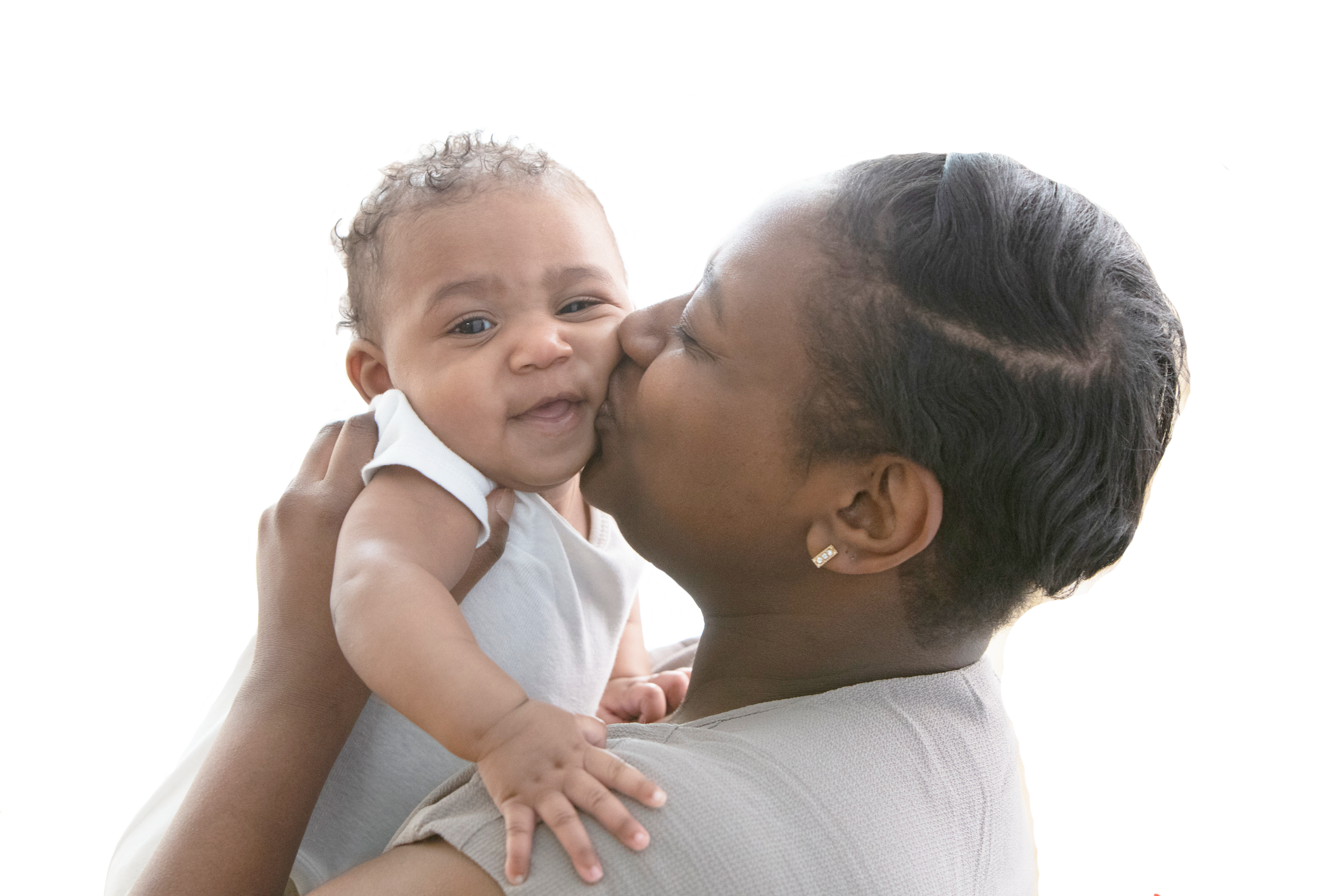 A mother kissing her baby