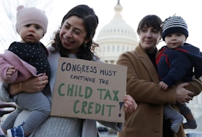 WASHINGTON, DC - DECEMBER 13: Local residents, Cara Baldari and her nine-month-old daughter Evie (L) and Sarah Orrin-Vipond and her eight-month-old son Otto (R), join a rally in front of the U.S. Capitol December 13, 2021 in Washington, DC. ParentsTogether Action held a rally with parents, caregivers and children to urge passage of the Build Back Better legislation to extend the expanded Child Tax Credit that will expire on January 15, 2022. (Photo by Alex Wong/Getty Images)