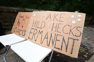 BROOKLYN, NEW YORK - JULY 12: Hand drawn signs to celebrate new monthly Child Tax Credit payments and urge congress to make them permanent outside Senator Schumer's home on July 12, 2021 in Brooklyn, New York. (Photo by Bryan Bedder/Getty Images for ParentsTogether)