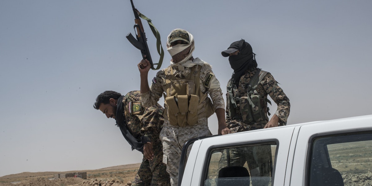NINEVEH, IRAQ - JUNE 20: Iraqi PMF fighters on June 20, 2017 on the Iraq-Syria border in Nineveh, Iraq. The Popular Mobilisation Front (PMF) forces, composed of majority Shi'ite militia, part of the Iraqi forces, have pushed Islamic State militants from the north-western Iraq border strip back into Syria. The PMF now hold the border, crucial to the fall of Islamic State in Mosul, blocking the Islamic State supply route for militants from Syria to Mosul. (Martyn Aim/Getty Images).