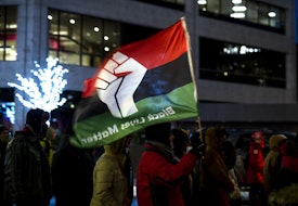MINNEAPOLIS, MN - DECEMBER 08: Protesters march in the streets near the Hennepin County Government Center on December 8, 2021 in Minneapolis, Minnesota. Opening statements began today in the trial of former Brooklyn Center police officer Kim Potter, who is charged with manslaughter in the April 2021 shooting death of Daunte Wright. Potter says she thought she was using her Taser when she shot Wright with her handgun. (Photo by Stephen Maturen/Getty Images)