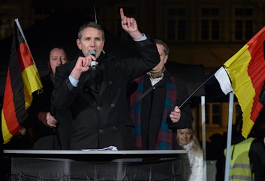 ERFURT, GERMANY - JANUARY 13: Bjoern Hoecke, head of the AfD (Alternative fuer Deutschland, or Alternative for Germany) in Thuringia, speaks to supporters at the first AfD Thuringia rally since the Cologne sex attacks on January 13, 2016 in Erfurt, Germany. Hoecke, who is on the far-right wing of the AfD, is demanding an immediate closure of Germany's borders to refugees and the expulsion of foreigners with criminal records. Over 500 women have filed charges including molestation, in some cases robbery and even rape following the gathering of hundreds of North African men, many of them were from Morocco and Algeria, at Cologne's Hauptbahnhof main railway station on New Year's Eve. The incident has caused heated discussion in Germany over the government's open-door policy for refugees. In 2015 Germany registered 1.1 million new migrants and refugees. (Photo by Jens Schlueter/Getty Images)