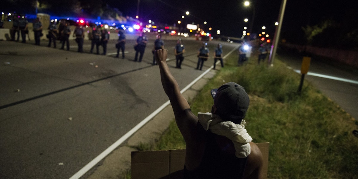 ST. PAUL, MN - JULY 09: A protestor raises his fist on shut down highway I-94 on July 9, 2016 in St. Paul, Minnesota. Protests and marches have occurred every day since the police killing of Philando Castile on June 6, 2016 in Falcon Heights, Minnesota. (Photo by Stephen Maturen/Getty Images)