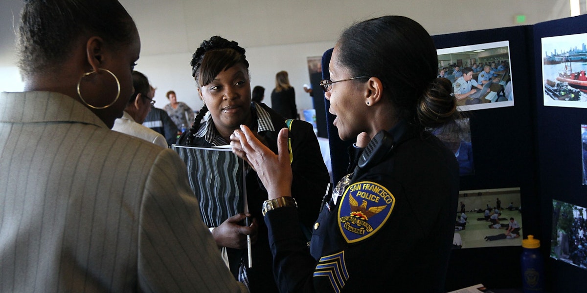 SAN FRANCISCO - MAY 12:  A San Francisco police department recruiter talks with job seekers during a job fair held by the California Employment Development Department and the San Francisco Veterans Employment Committee May 12, 2010 in San Francisco, California. Hundreds of job seekers attended the one-day job fair as the national unemployment rate sits at 9.9 percent.  (Photo by Justin Sullivan/Getty Images)