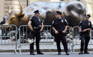 NEW YORK, NY - SEPTEMBER 17:  Police guard the famous bull statue during Occupy Wall Street protests in the Financial District on September 17, 2012 in New York City. Today is the one year anniversary of Occupy Wall Street and protesters are planning various actions and events throughout the day.  (Photo by Mario Tama/Getty Images)