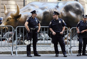 NEW YORK, NY - SEPTEMBER 17:  Police guard the famous bull statue during Occupy Wall Street protests in the Financial District on September 17, 2012 in New York City. Today is the one year anniversary of Occupy Wall Street and protesters are planning various actions and events throughout the day.  (Photo by Mario Tama/Getty Images)