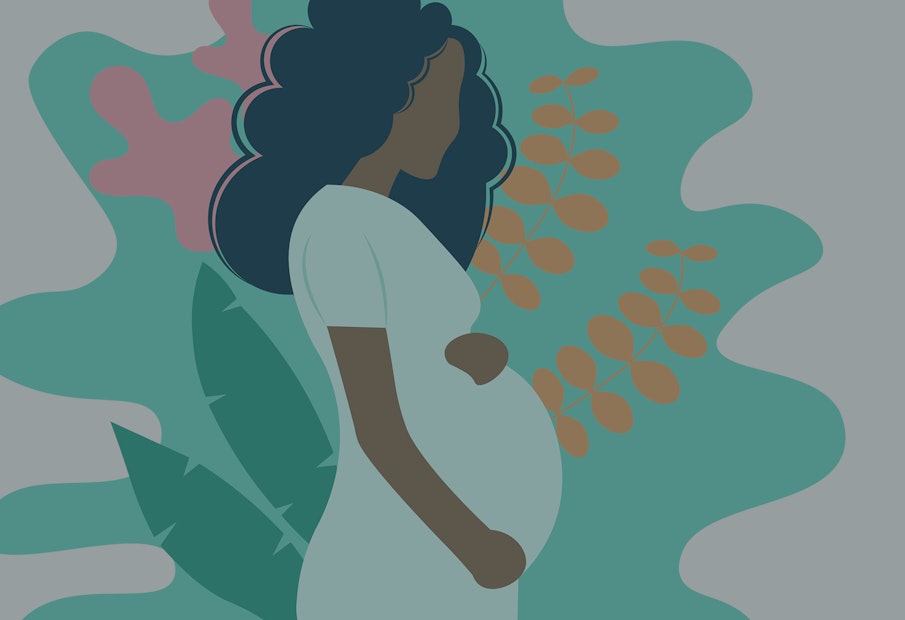 a pregnant woman standing in front of a plant