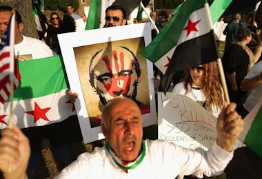 WASHINGTON, DC - OCTOBER 09:  About 100 people shout slogans as they gather outside the Russian embassy to protest against President Vladamir Putin and his country's involvement in Syria October 9, 2015 in Washington, DC. Syrian Americans and supporters of the Syrian people gathered to demonstrate against Russia's military build up and action in Syria and its four-year civil war.  (Photo by Chip Somodevilla/Getty Images)