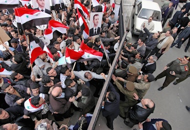 DAMASCUS, SYRIA - MARCH 10:  A pro-Assad demonstration quickly puts an end to a pro-democracy demonstration in front of the justice palace on March 10, 2005 in Damascus, Syria. The Lebanese Parliament emboldened by pro-Syrian demonstrations in Beirut voted to re-elect Lebanon's pro-Syrian Prime Minister, Omar Karami, who was forced stand down by pressure from opponents of Syria's occupation.  (Photo by Jeroen Kramer/Getty Images)