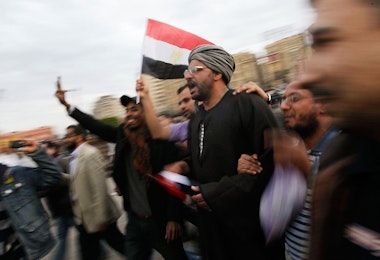 CAIRO, EGYPT - FEBRUARY 04:  Anti-government protesters march in Tahrir Square February 4, 2011 in Cairo, Egypt.  Clashes between anti- and pro-government factions in Egypt's central square quieted February 4, as anti-government protesters called for a 