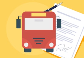 A red bus in front of a signed document.