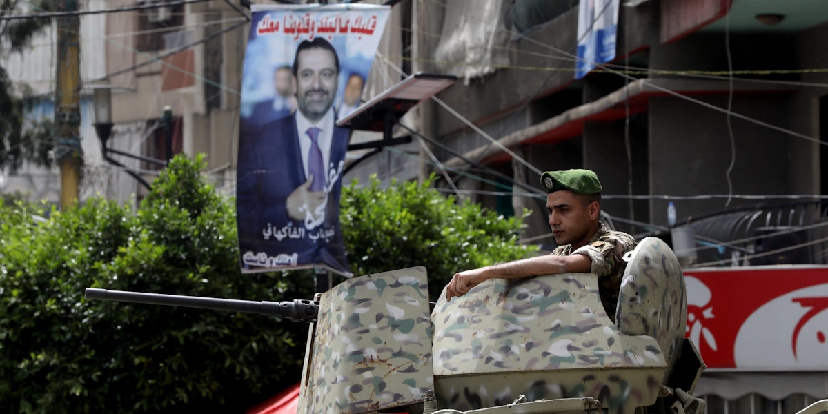 BEIRUT, LEBANON - MAY 15: A soldier stands guard near a poster featuring former prime minister Rafic Hariri on May 15, 2022 in the Tarik El Jdideh neighborhood of Beirut, Lebanon. Lebanese head to the polls for the first time since the protest movement of 2019, and amid the country's continued financial crisis. (Photo by Marwan Tahtah/Getty Images)