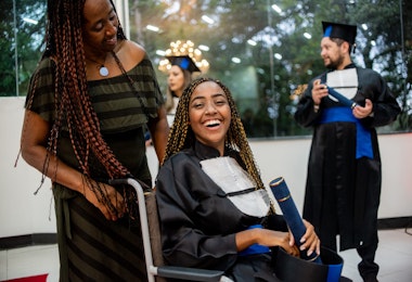 Portrait of woman in wheelchair on graduation day.