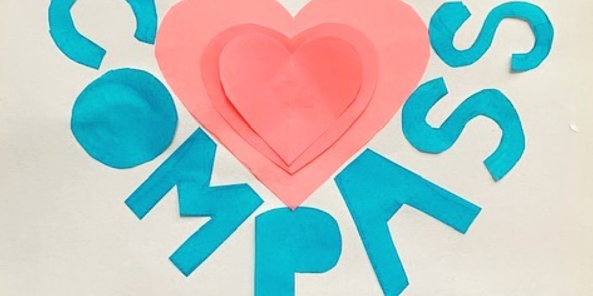 Children's artwork with a pink heart and the word Compass cut out of construction paper.