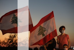 People wave Lebanese flags and chant to mark the one-year anniversary of anti-government protests on October 17, 2020 in Beirut, Lebanon.